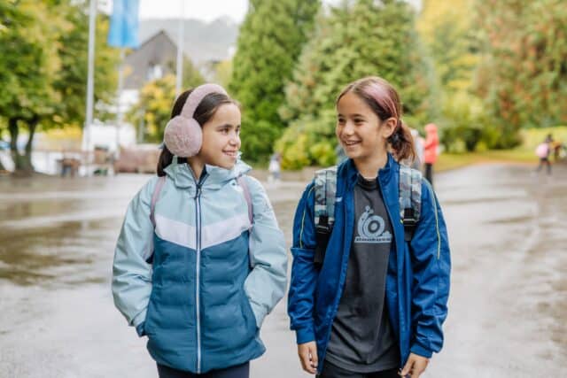 Two girls in conversation, representing the engaging and supportive learning environment at ISZL.