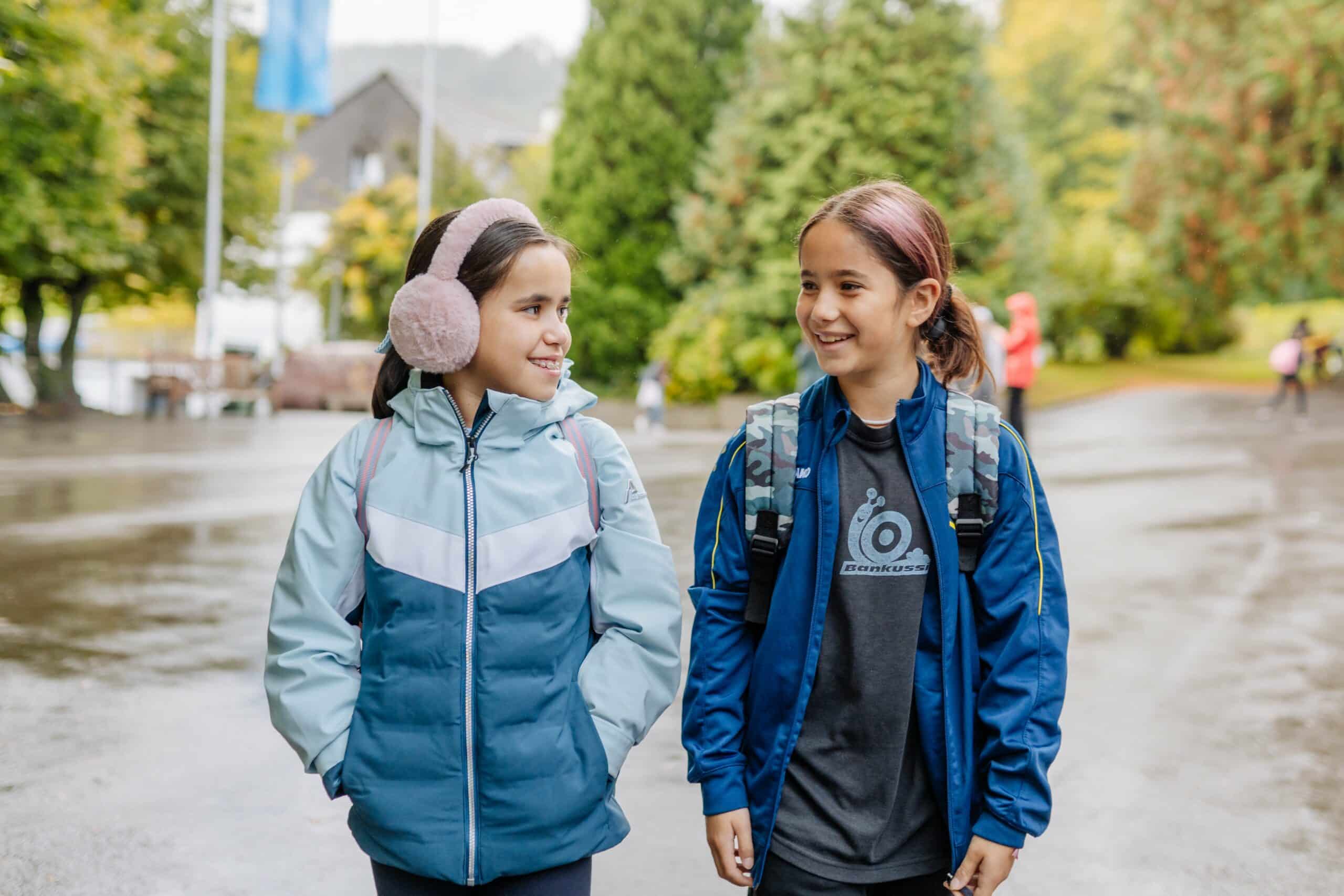 Two girls in conversation, representing the engaging and supportive learning environment at ISZL.