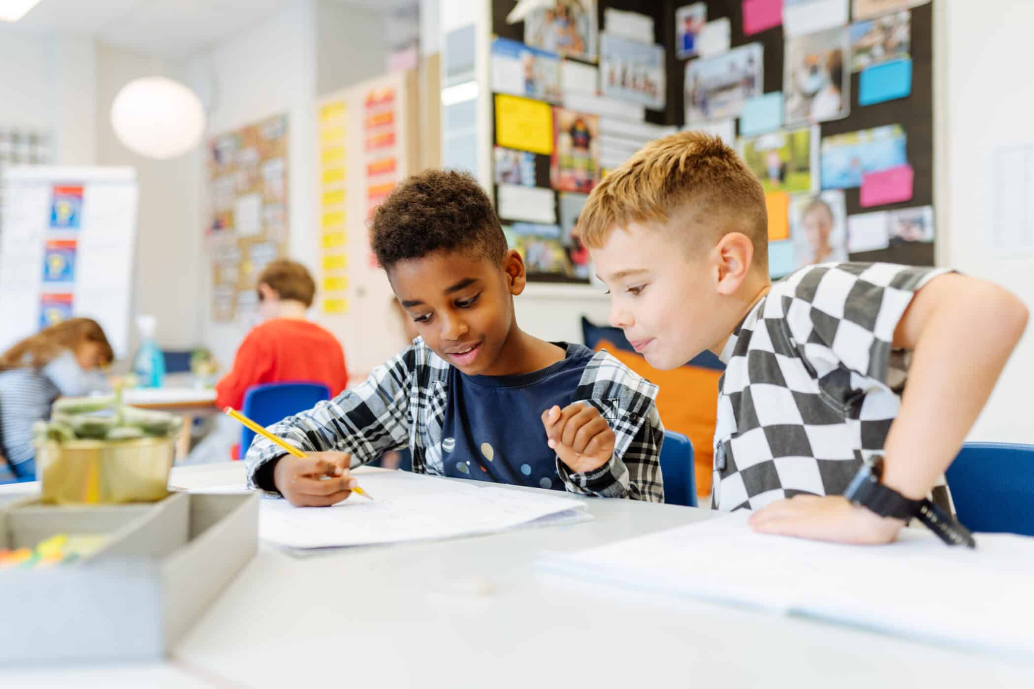 Two boys reading a book together, reflecting ISZL’s welcoming and international learning environment.