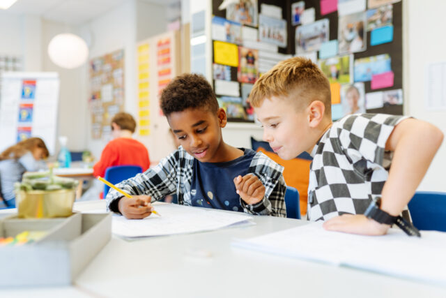 Two boys reading a book together, reflecting ISZL’s welcoming and international learning environment.