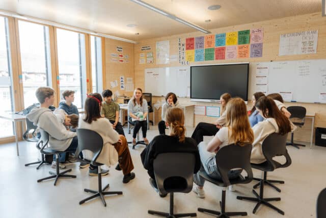 Teacher leading a classroom circle activity, reflecting ISZL’s collaborative and student-centered learning environment.