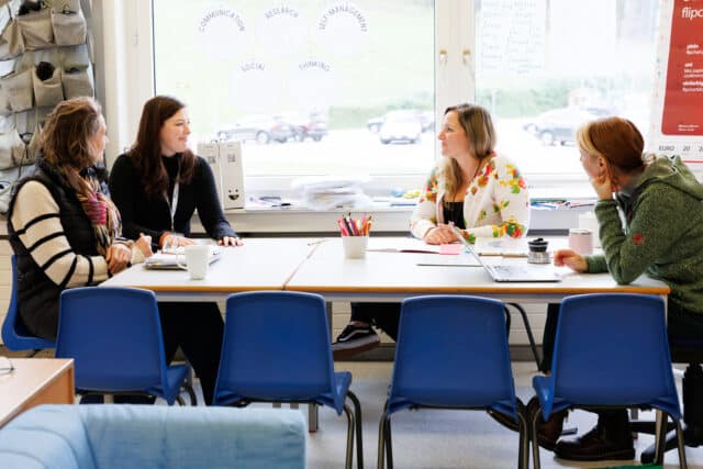 Safeguarding team collaborating at a table, reflecting ISZL’s commitment to student protection and community well-being.