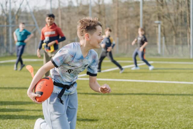 Middle School students learning to play tag ball during a sports activity.