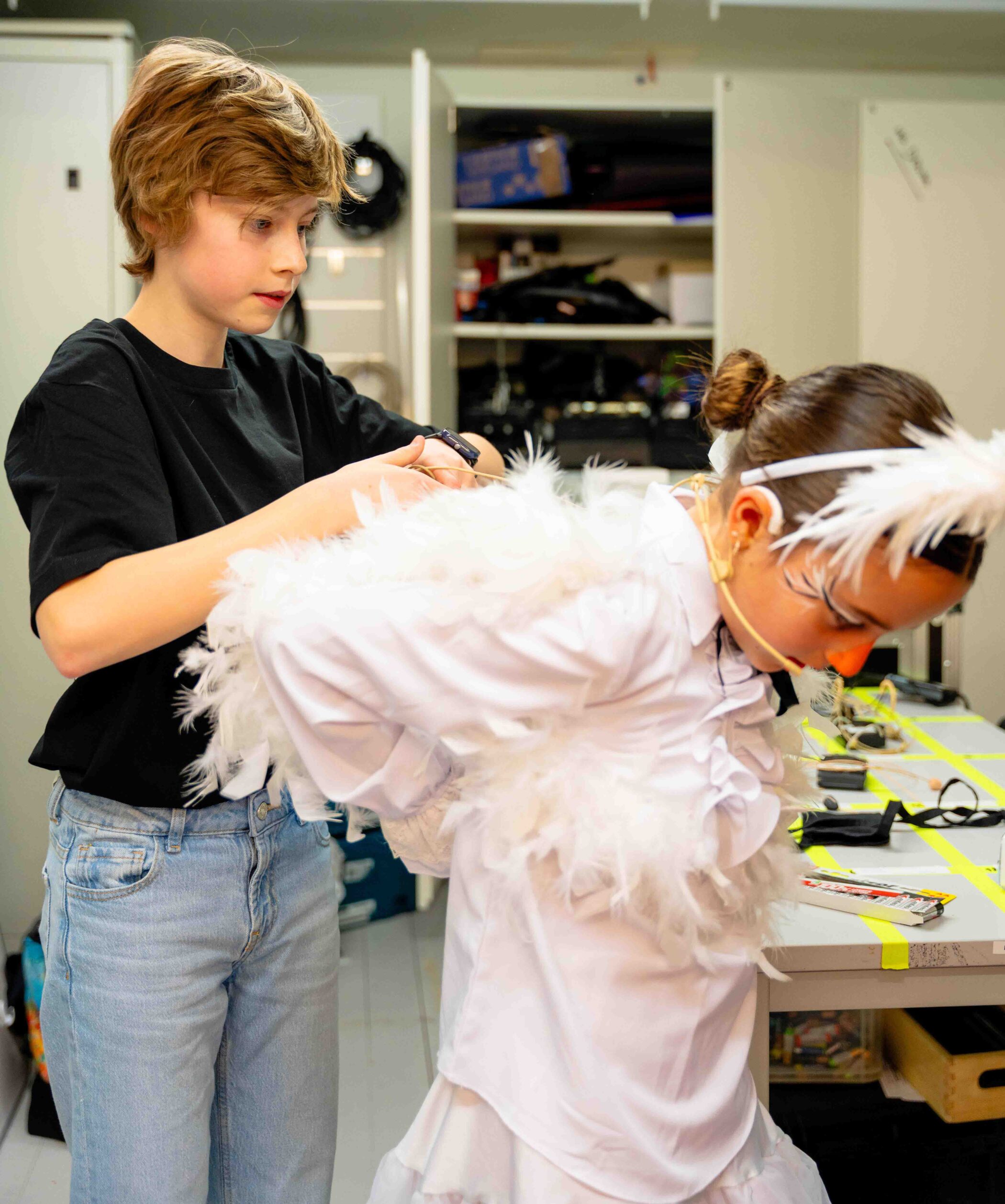 Set design student organizing props and scenery backstage before the play begins