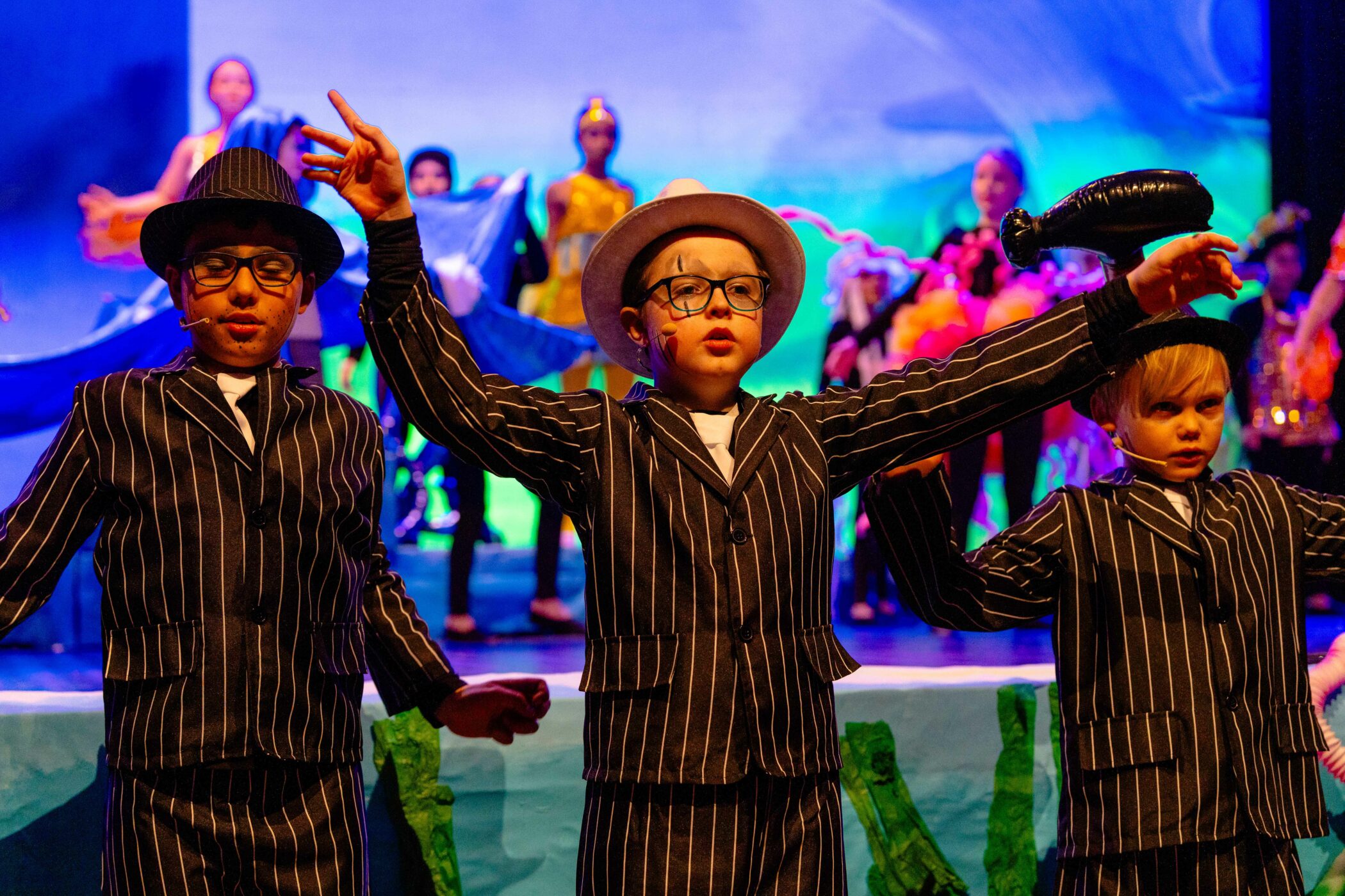 Three primary school students dressed in character suits backstage for the Nemo school play