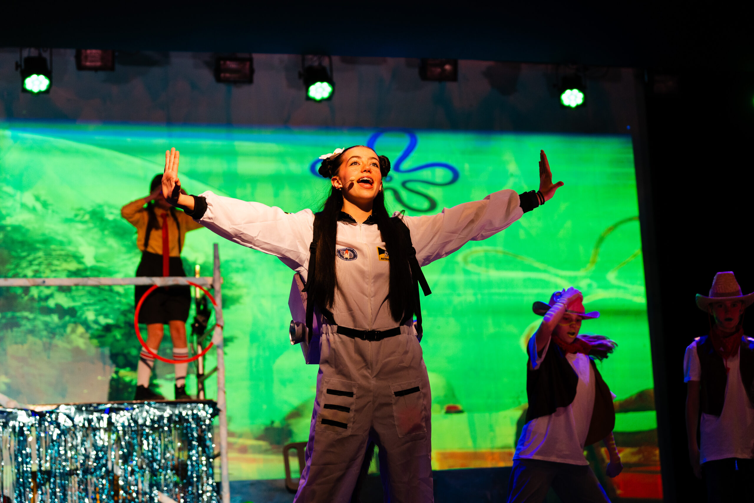 Student performing as the protagonist in the Spongebob musical, showcasing creativity and talent at ISZL.