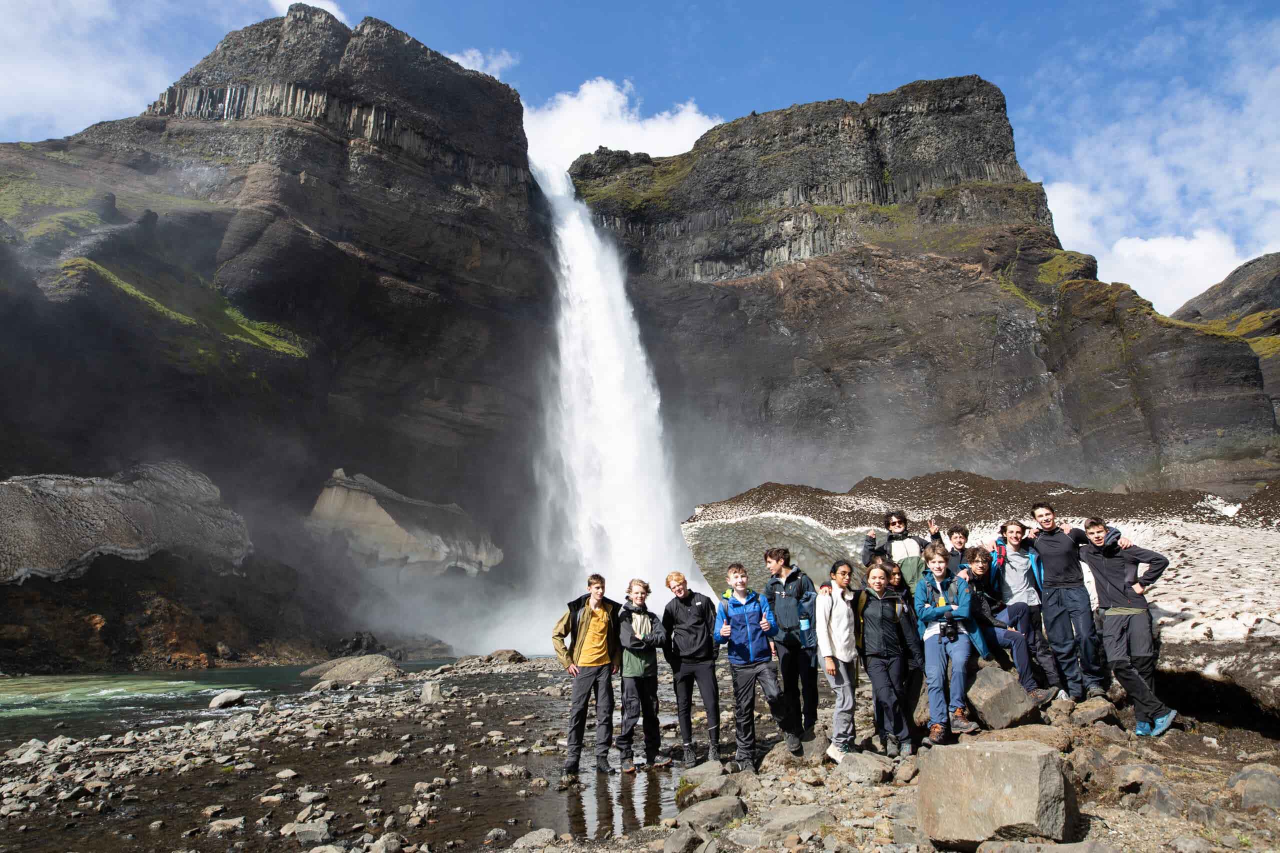 students in Iceland by a waterfall