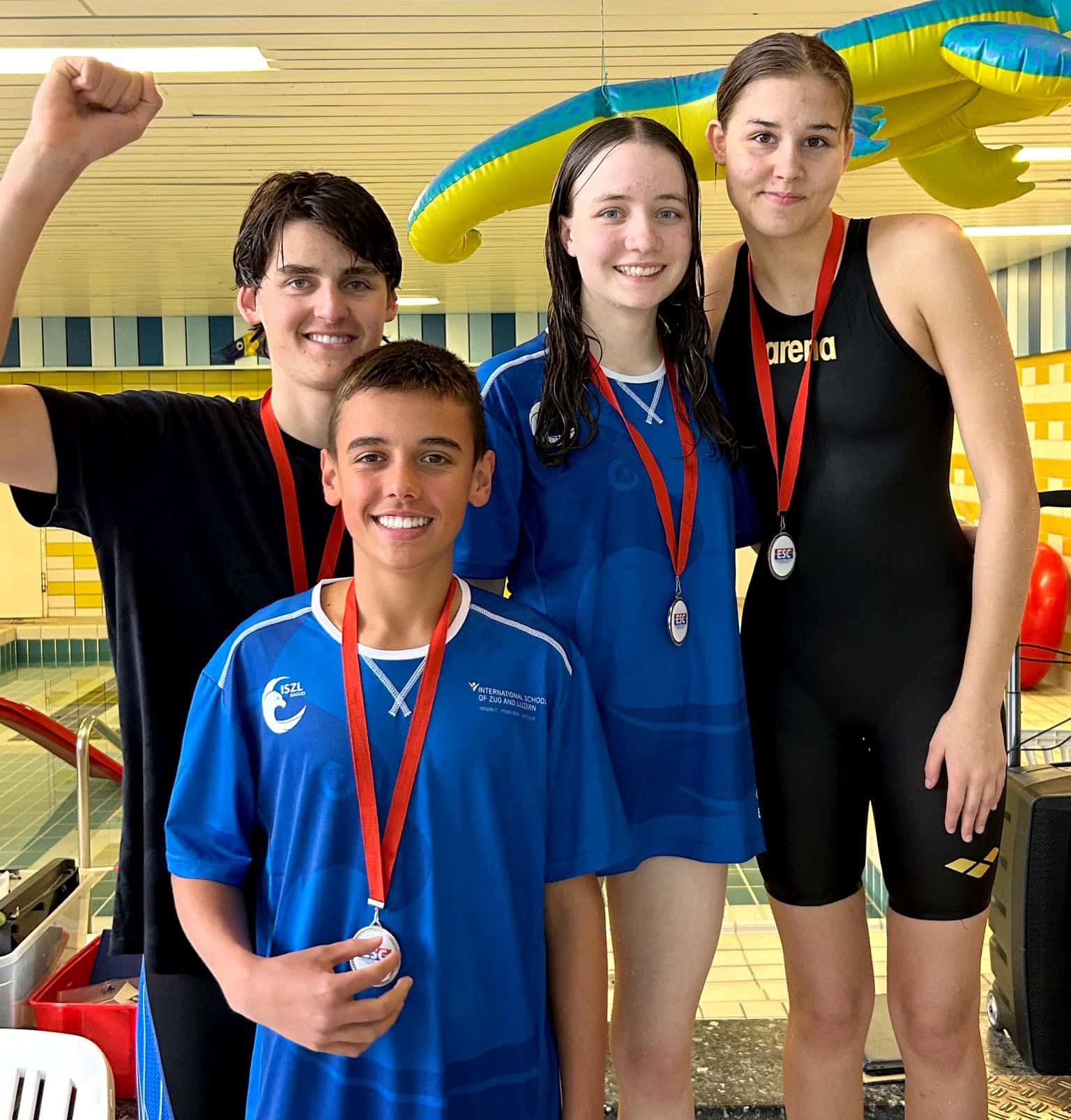 ISZL Middle school student wearing a medal at a swimming competition