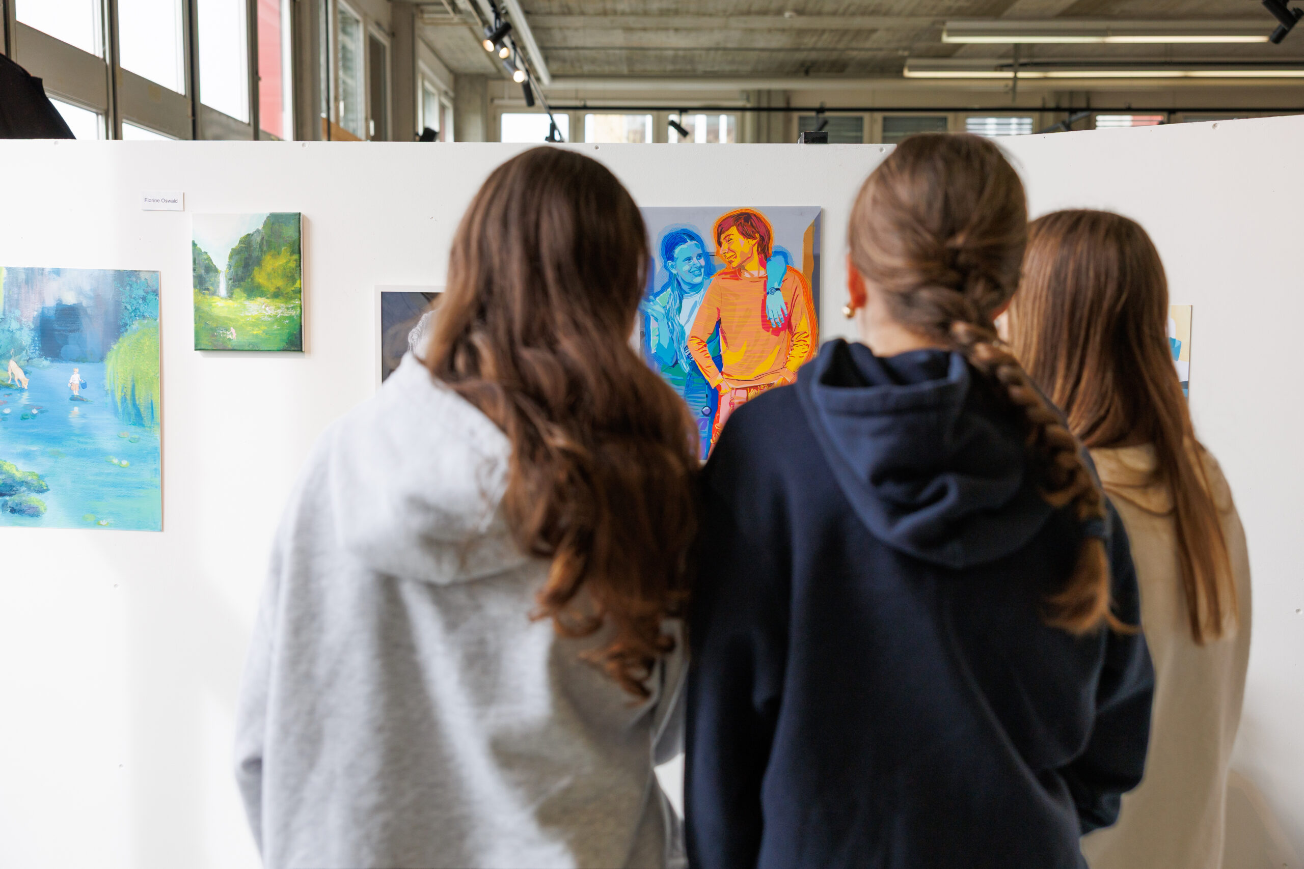 high school students viewing art exhibition