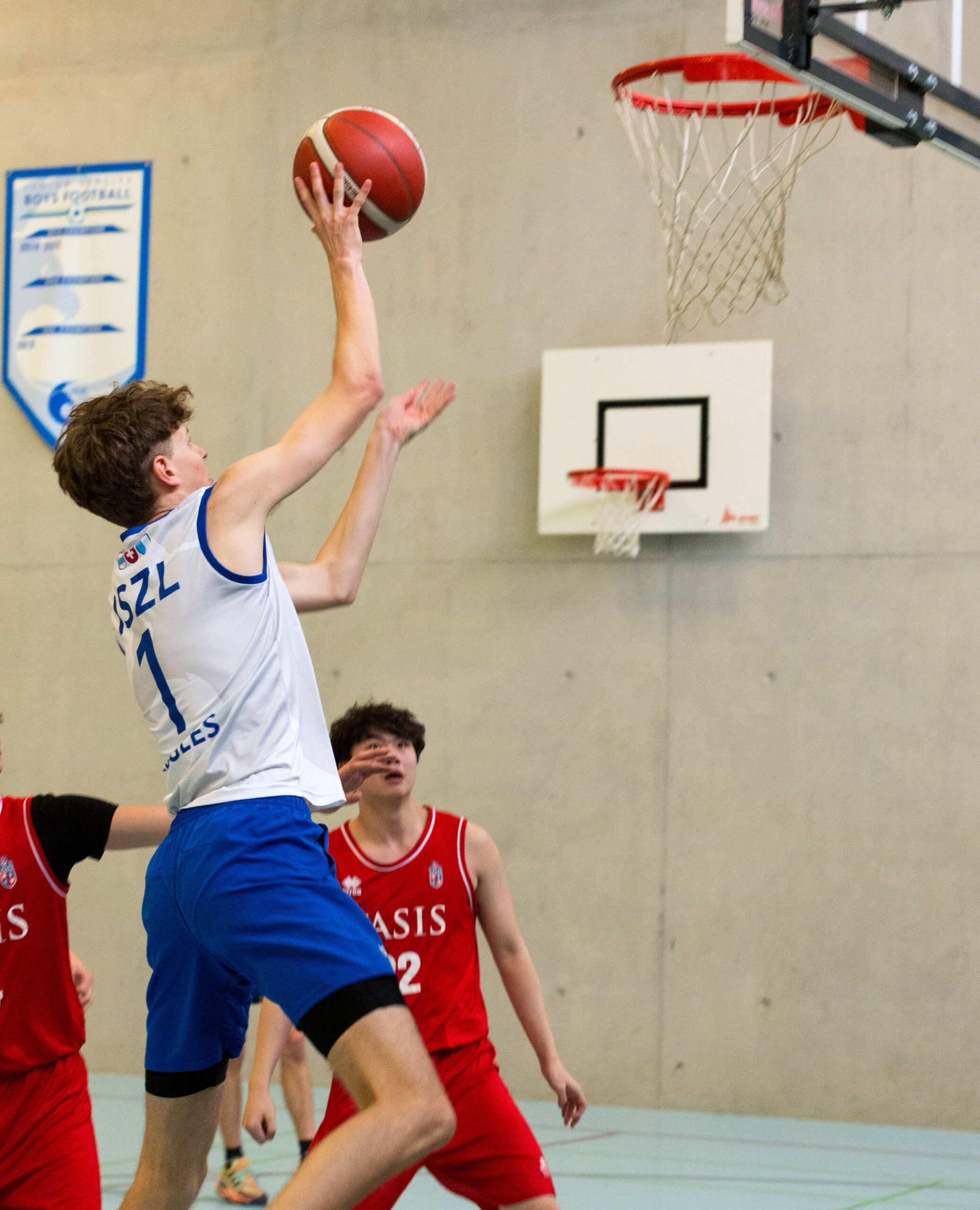 ISZL High school student about to score during a basketball game.