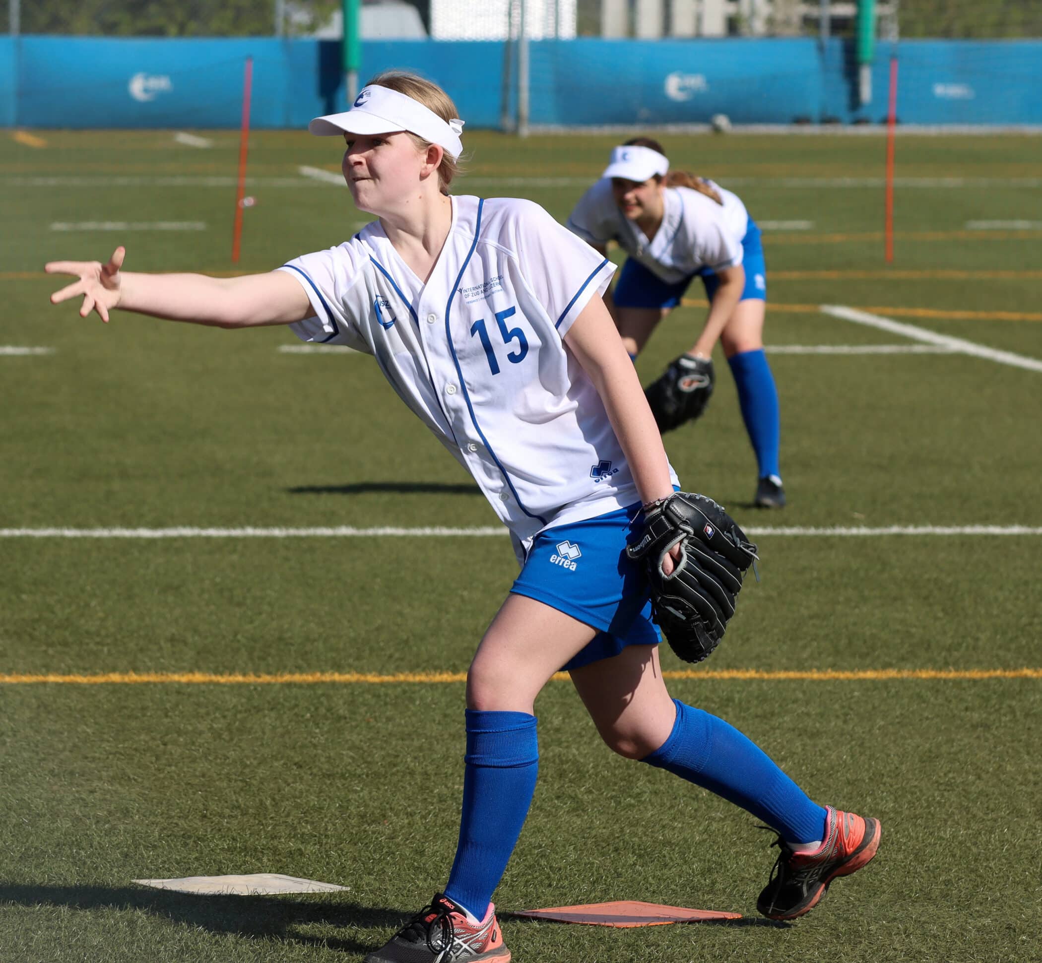 ISZL Female student swinging a bat during a softball game