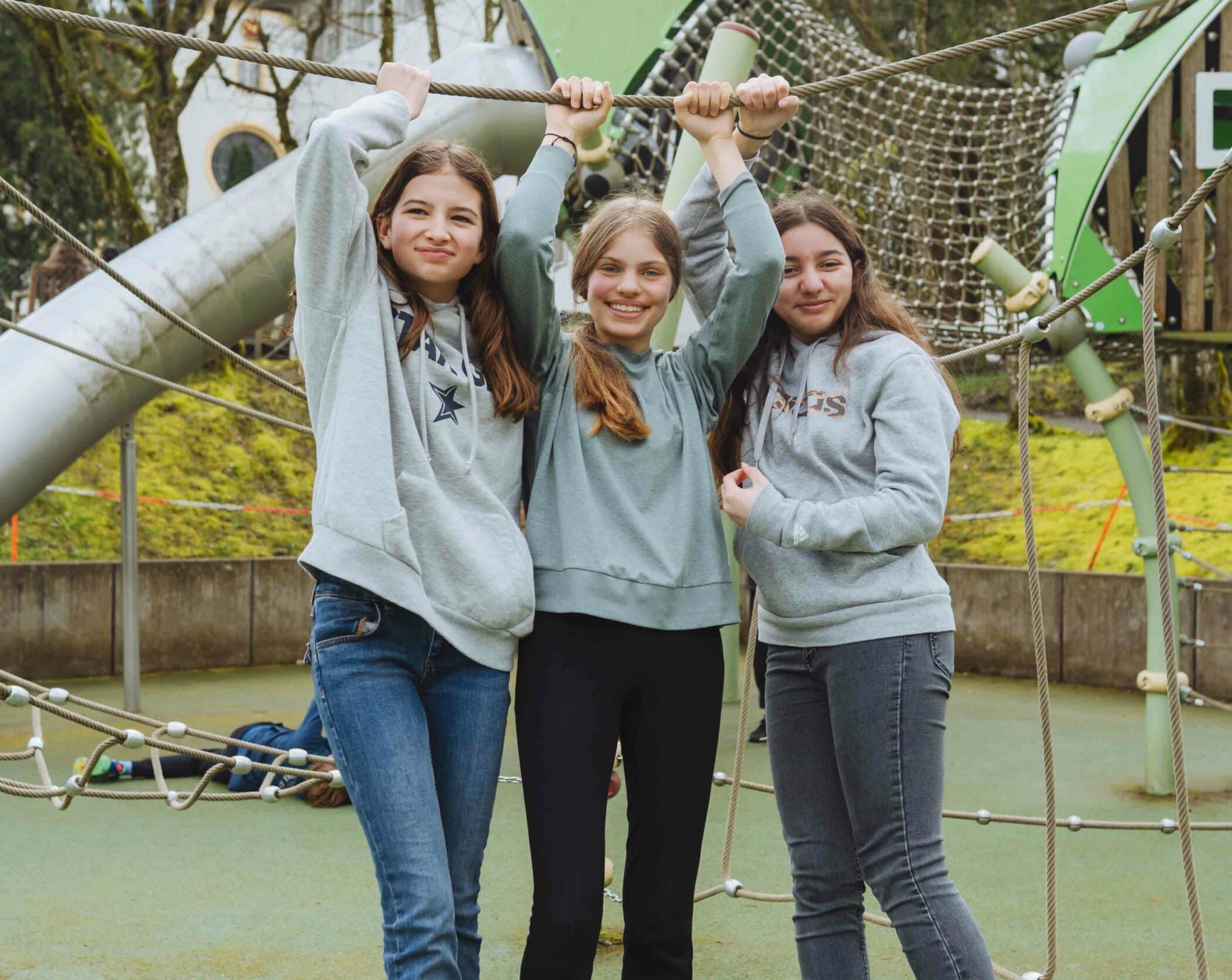 three middle school students friends in the playground area