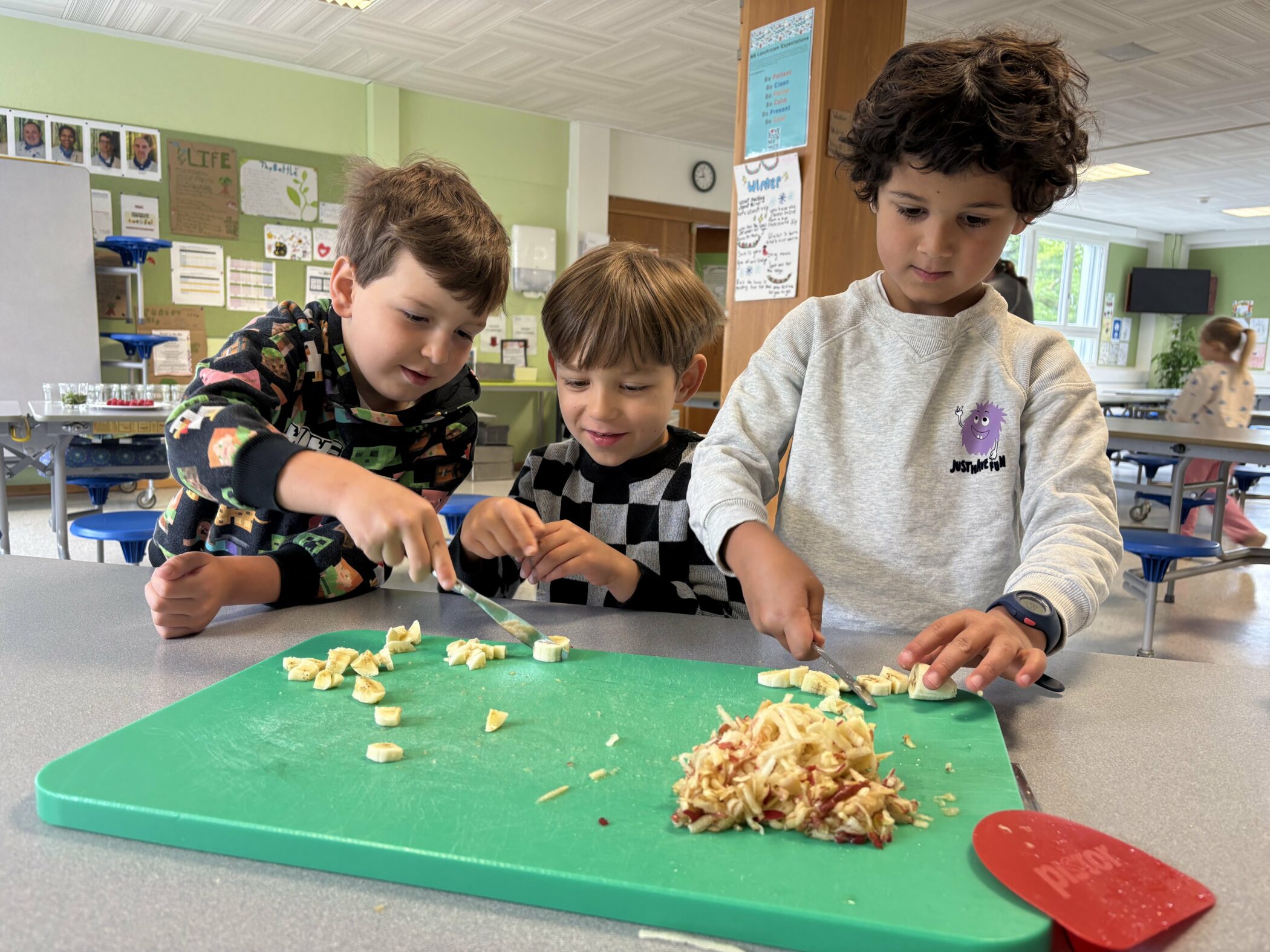 Children gathered around a table learning about healthy ingredients.
