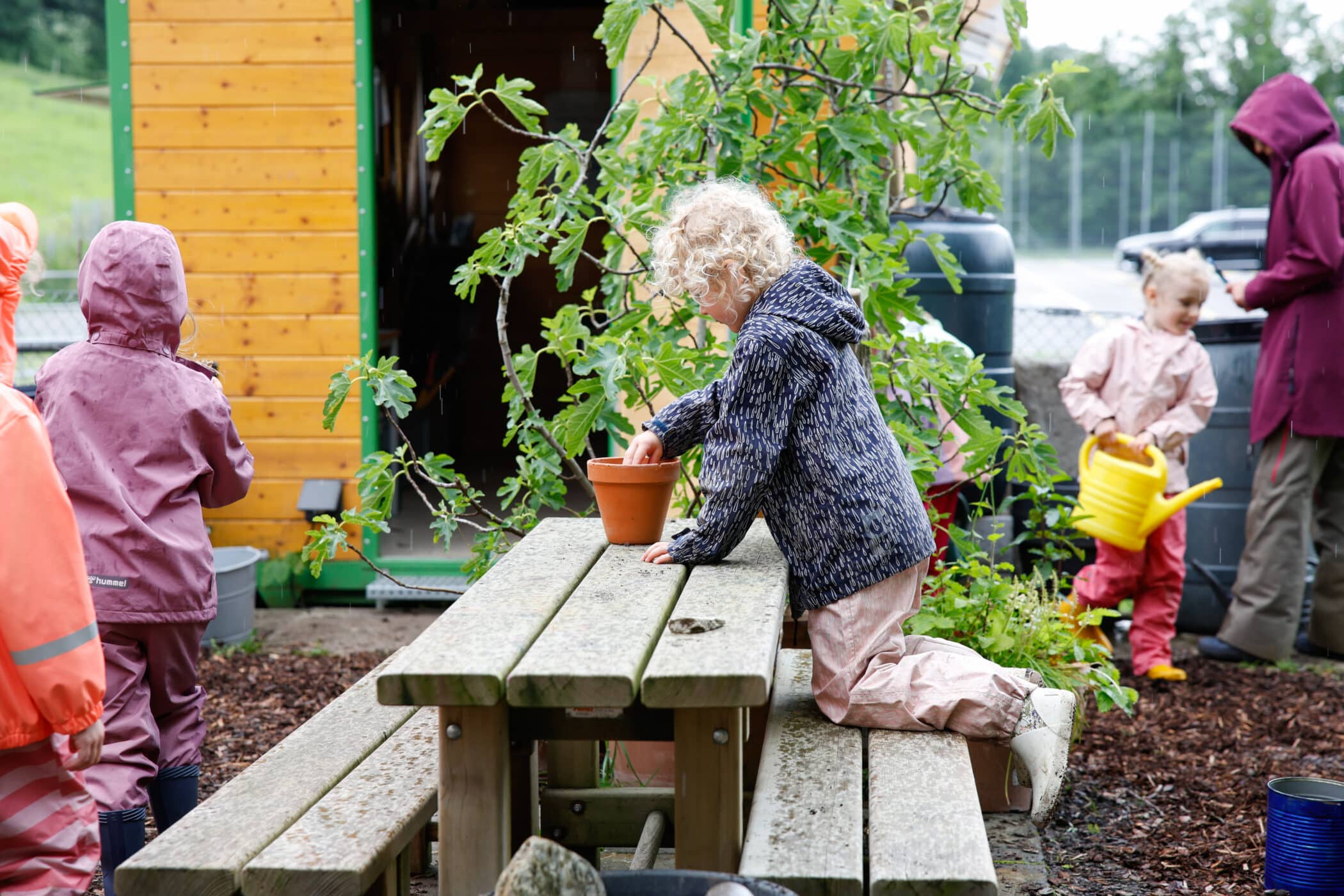 child tending to the plants on zug campus