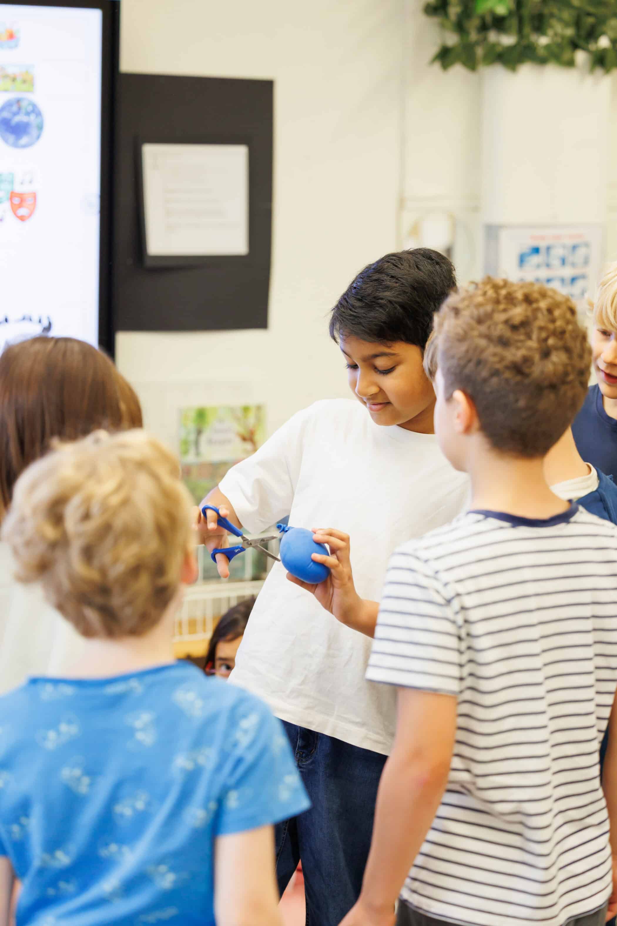 young students learning with balloons