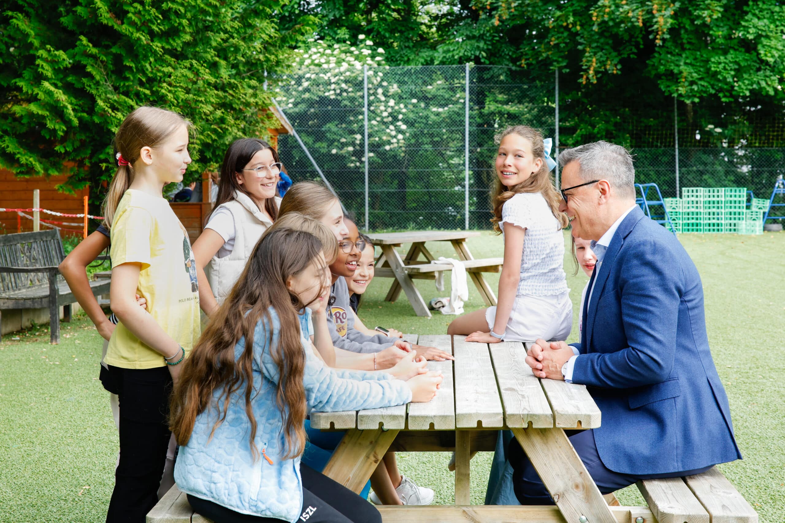 smiling students with school director