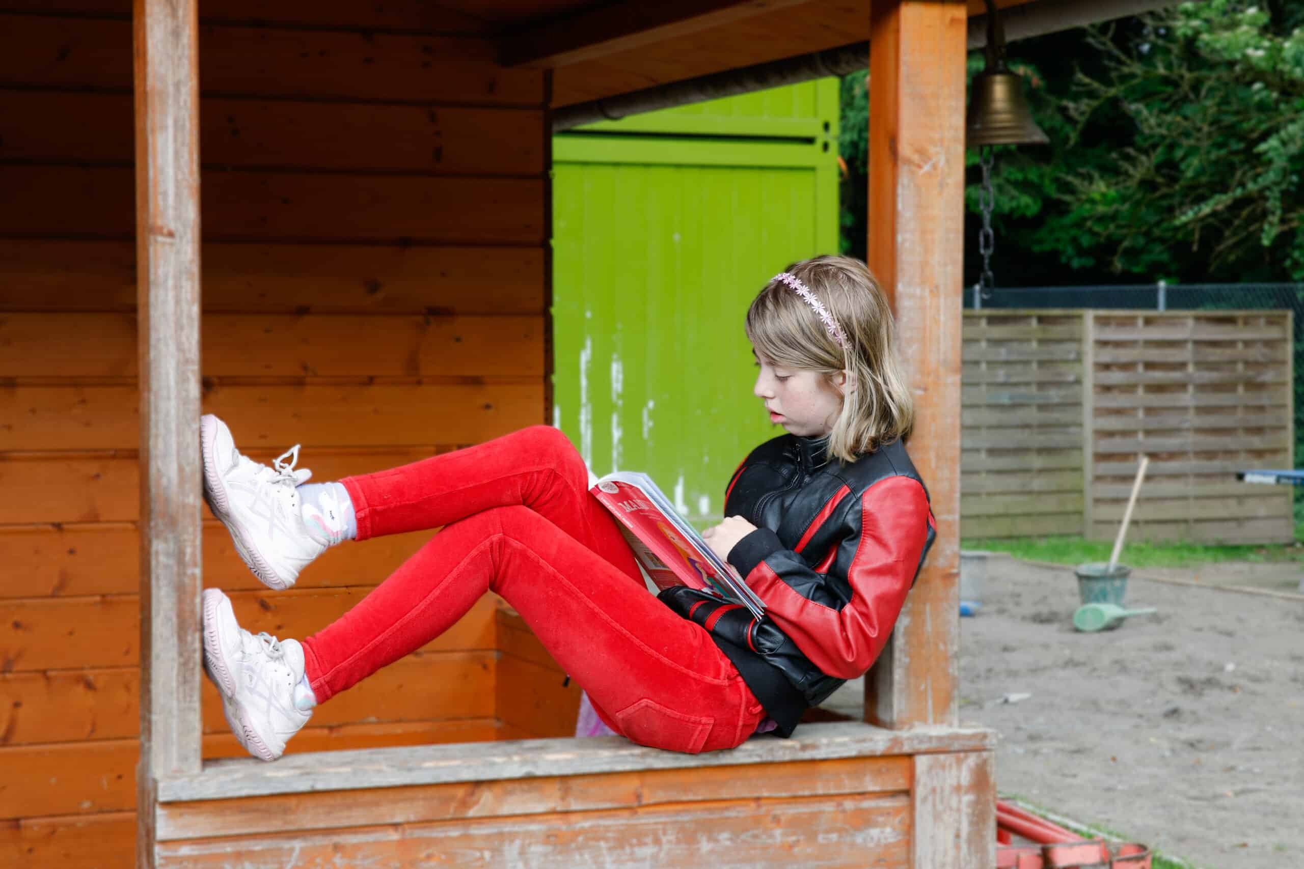 primary student reading in the garden