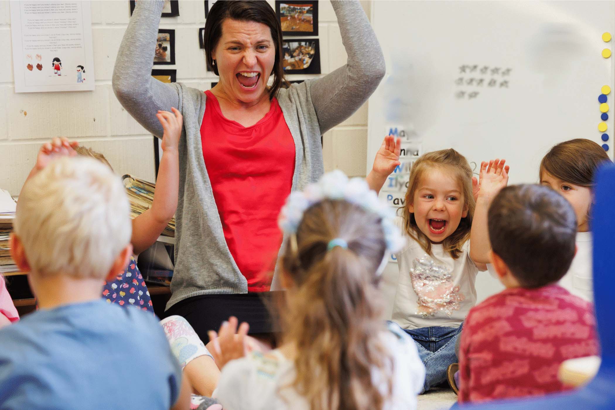 teacher and students laughing