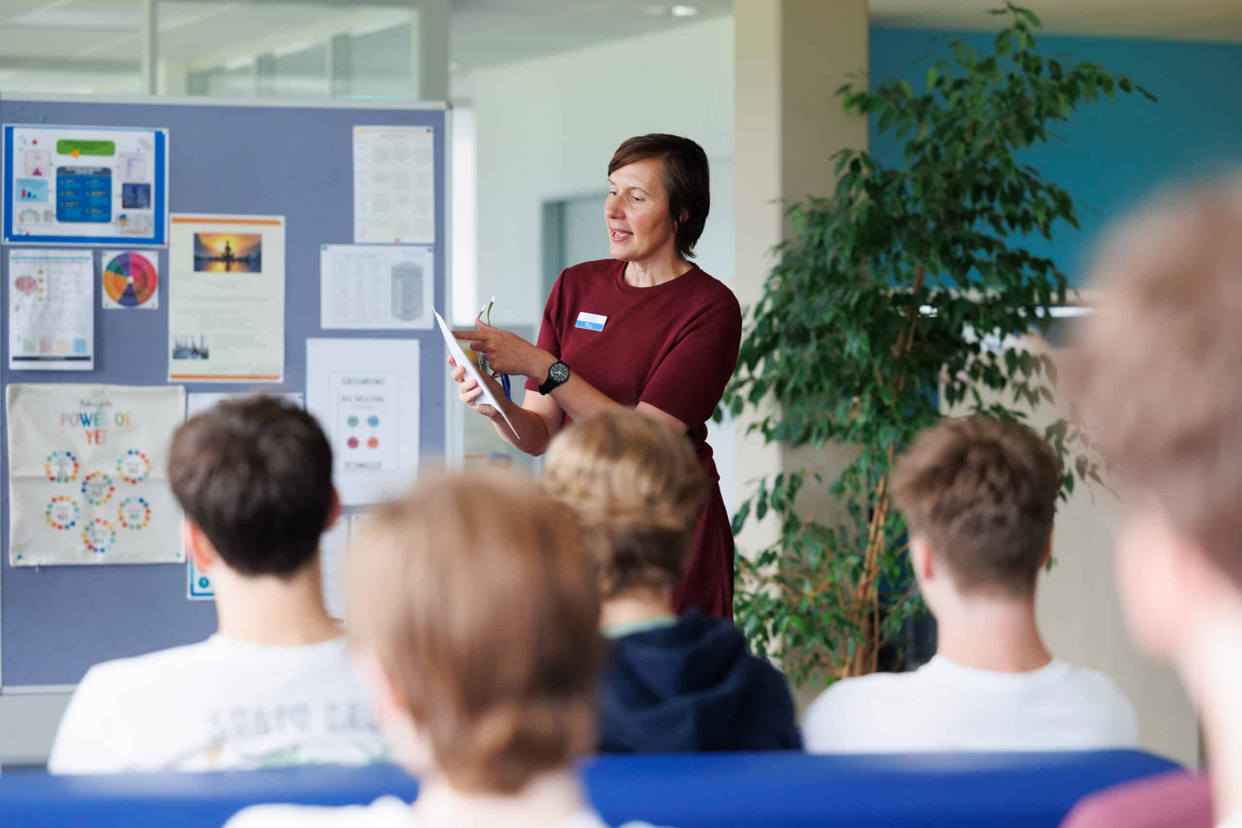 University advisor at ISZL presenting to high school students.