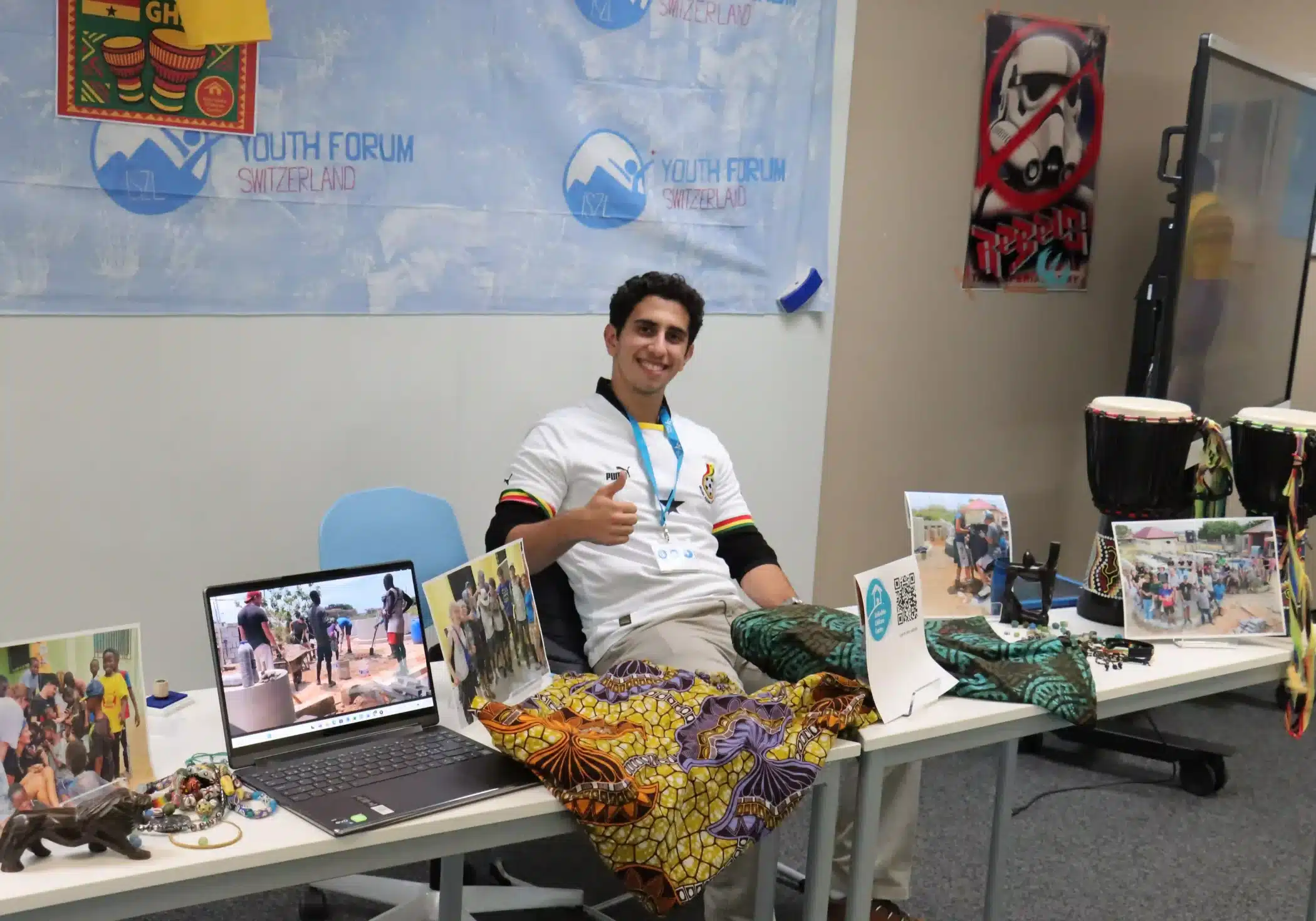 ISZL student presenting their Africa trip experience and product at an exhibition table during the forum.