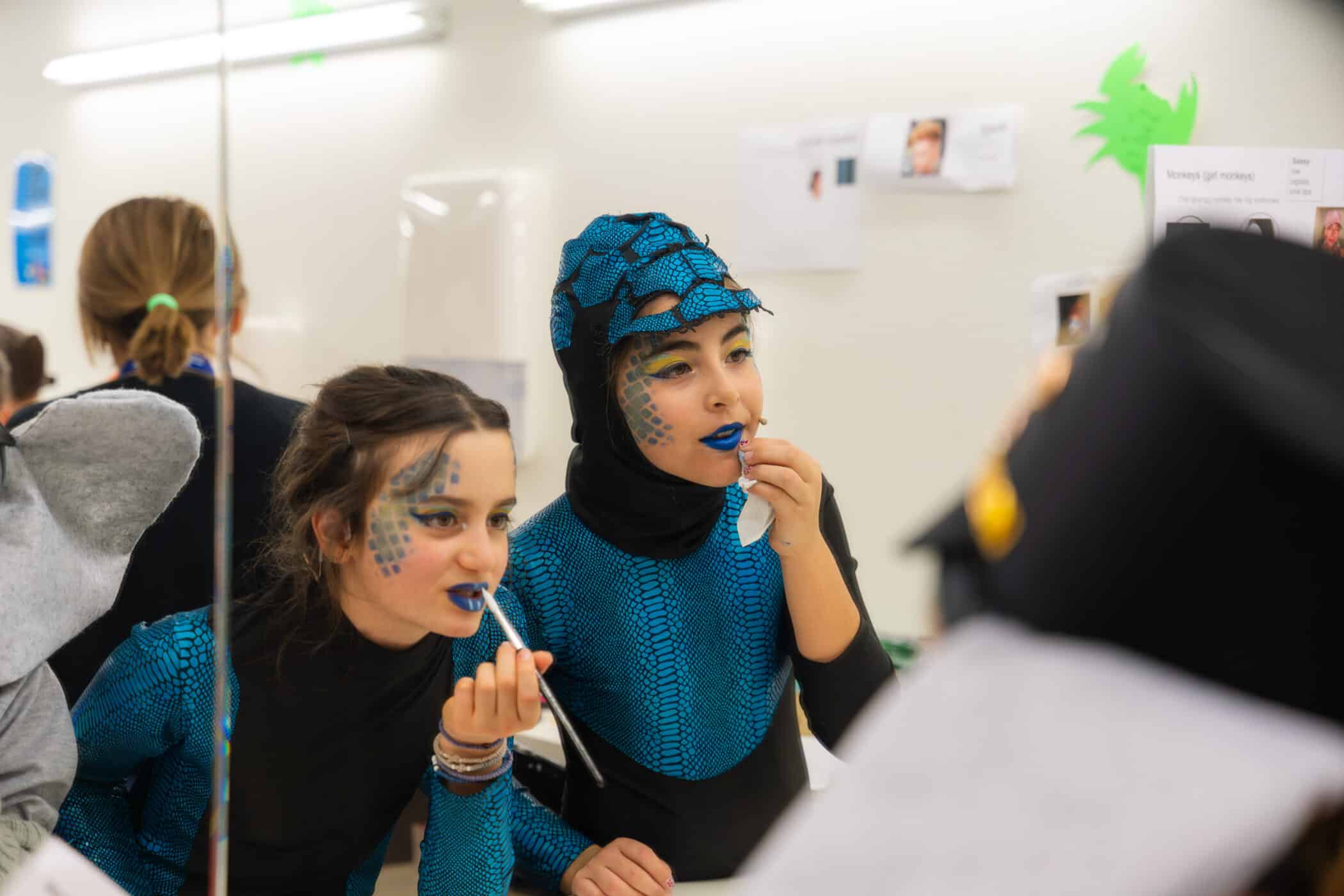 backstage students putting on stage makeup