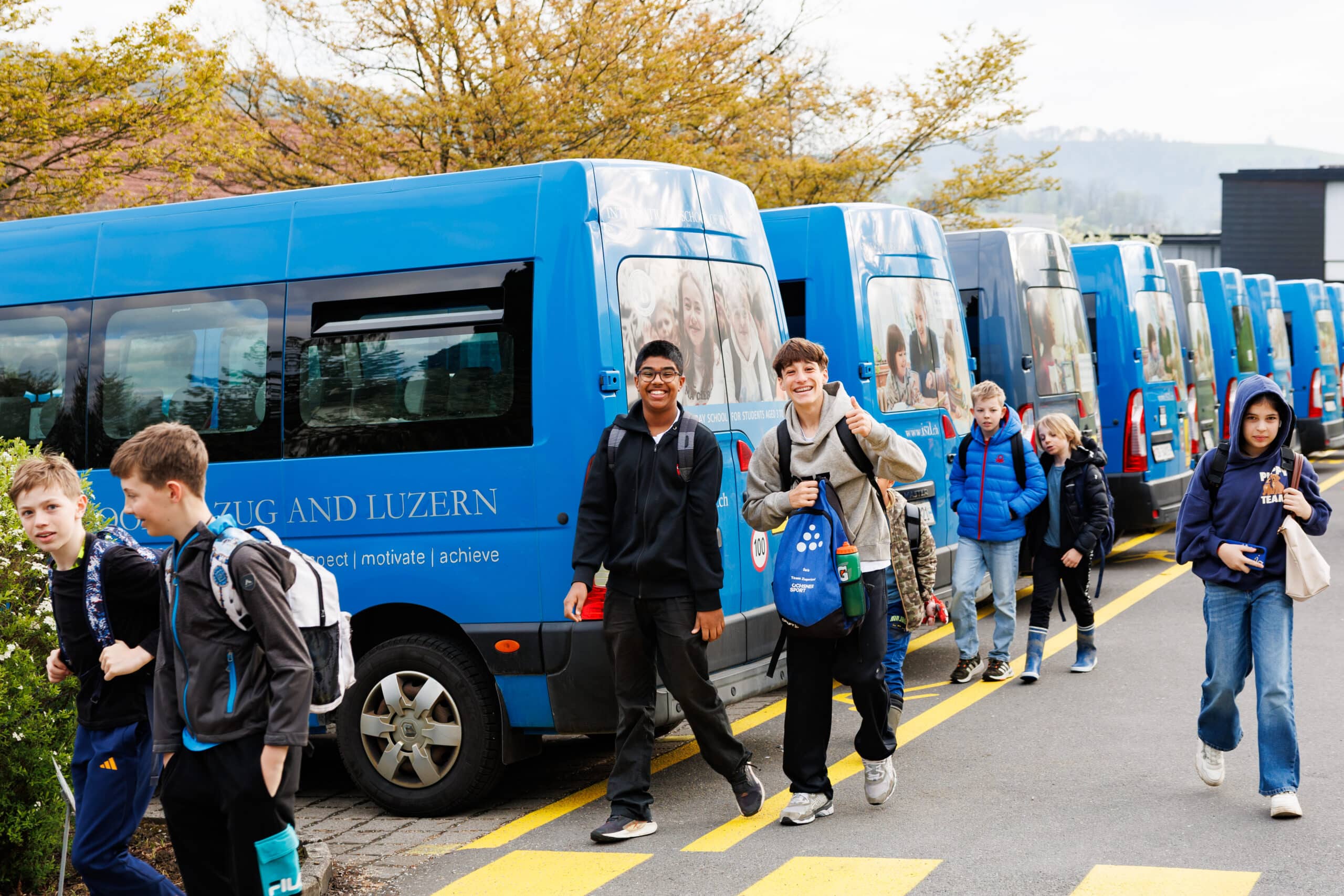 middle school students getting off the bus smiling