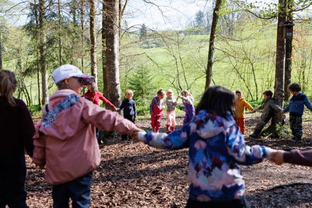young students sitting by the fire pit eating
