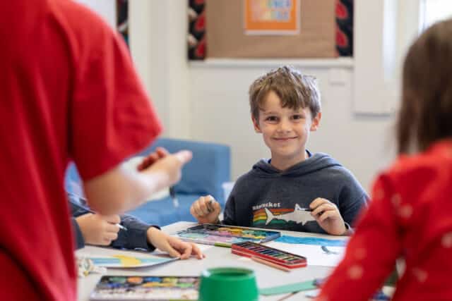 primary student grinning in classroom