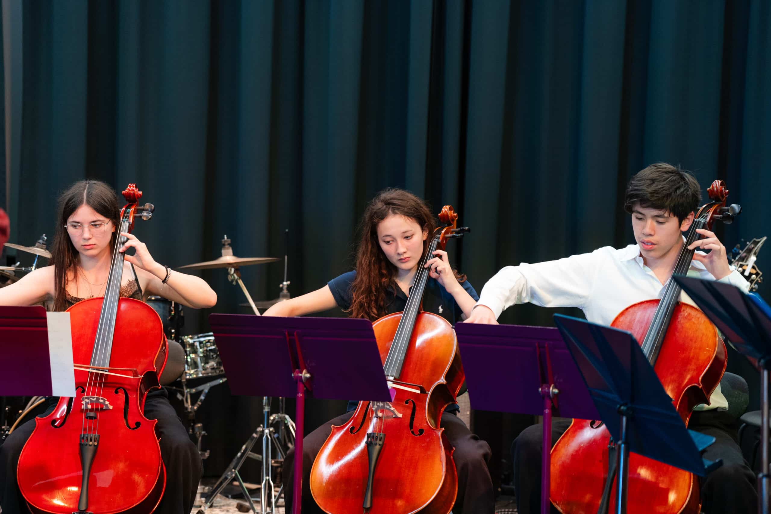 high school students playing chello