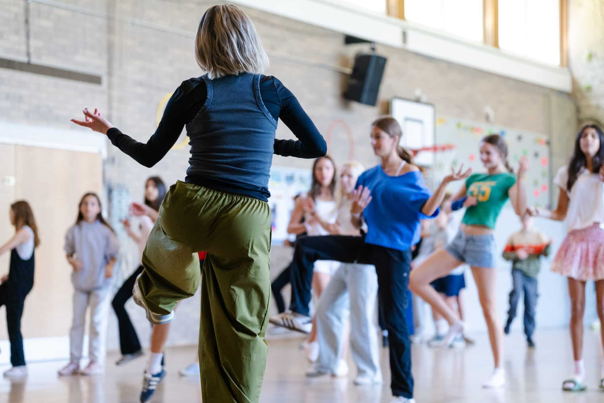 Students learning to dance in a dance workshop for arts week