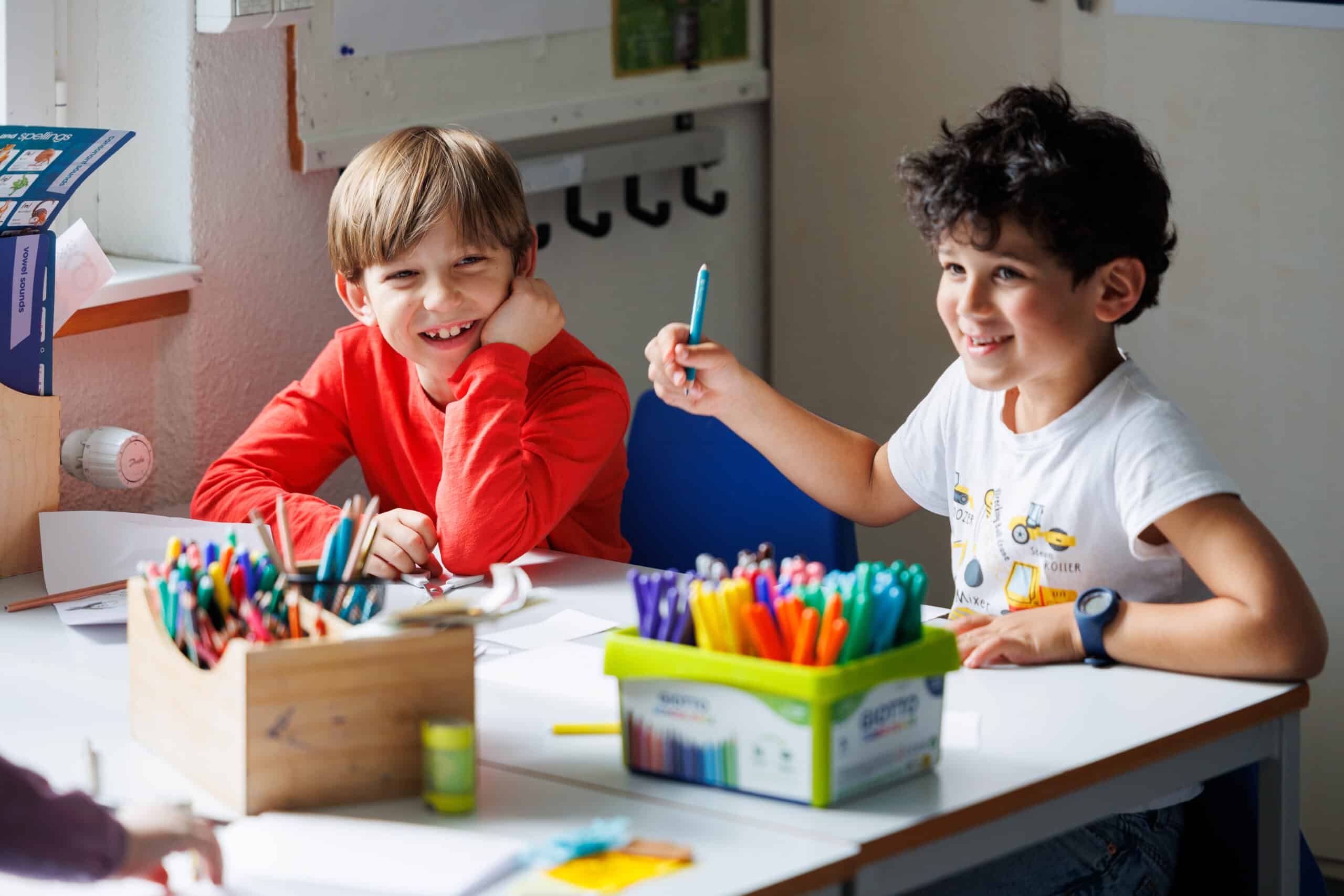 primary boys learning with coloured pens