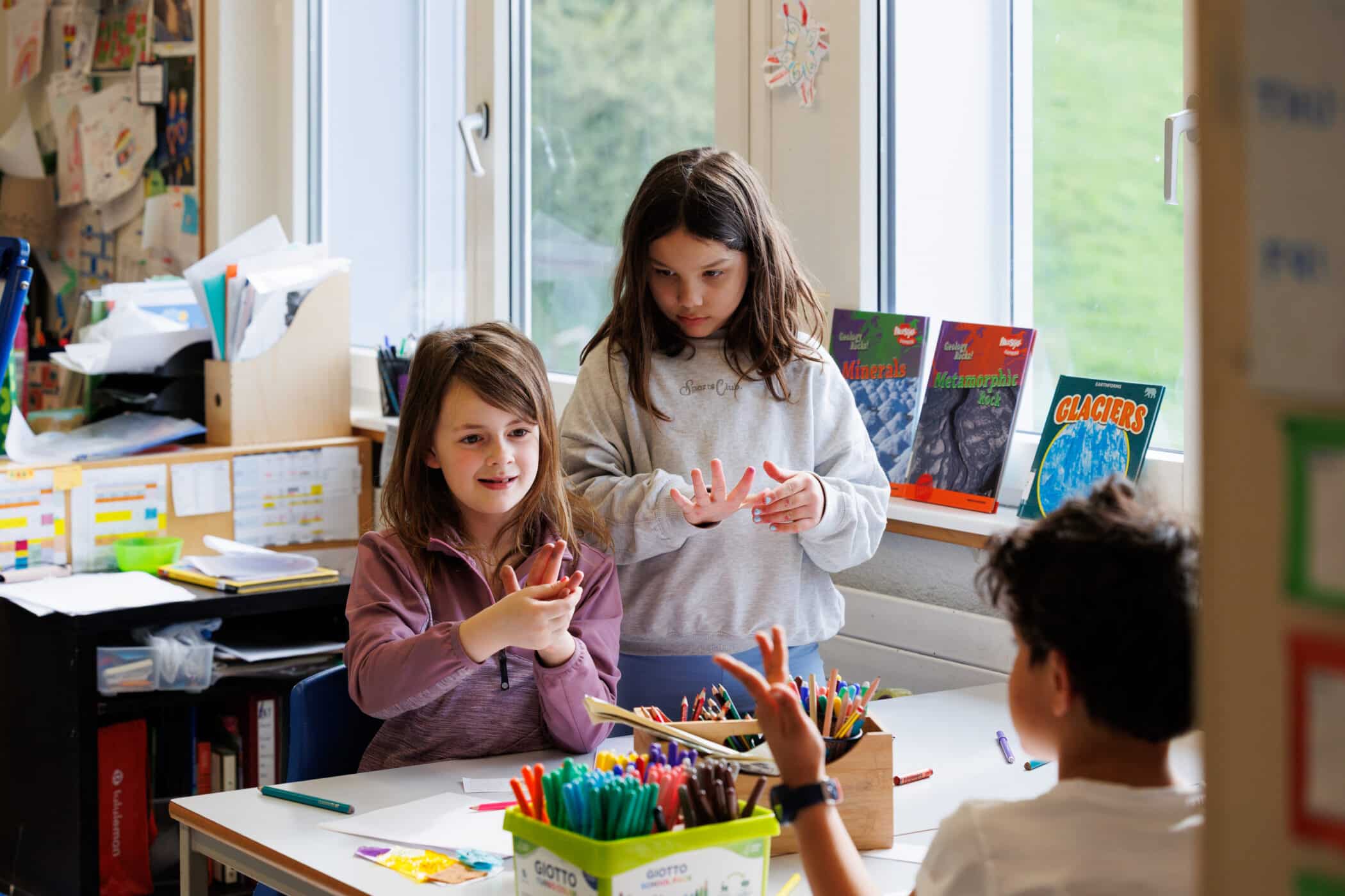 primary girls in the classroom learning across subjects
