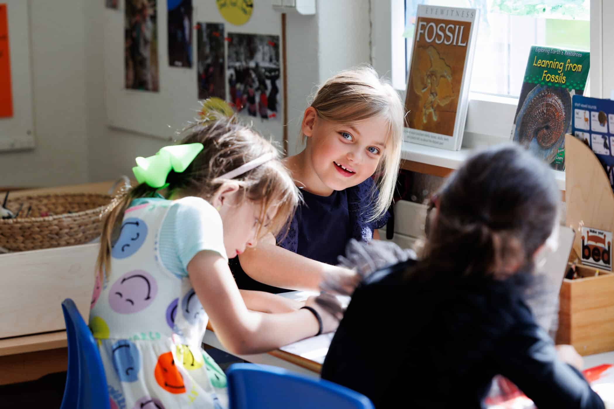 primary students writing in their books