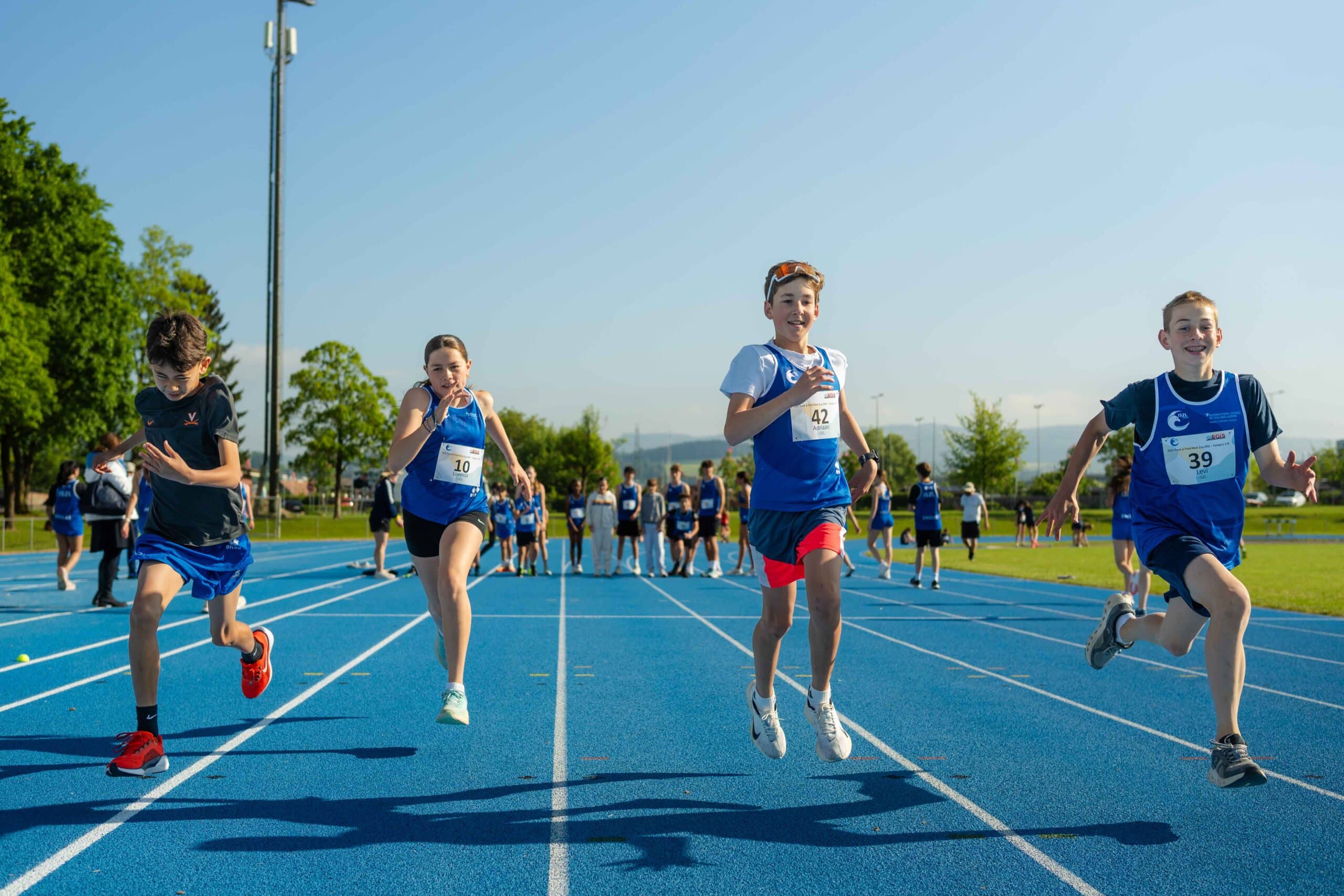 ISZL Middle School students running during a track and field competition.
